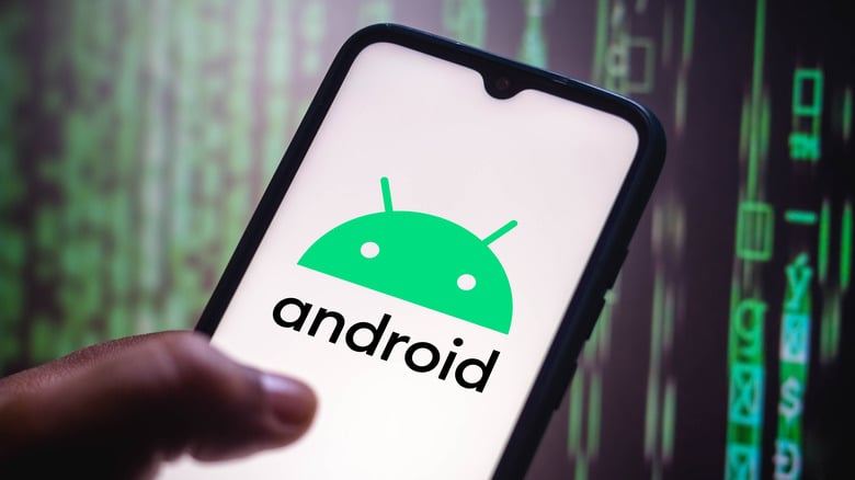 A hand holds a phone, with the Android logo on it.